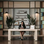 Confident woman working in a stylish, modern office with a focus on productivity and organization.